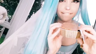 Belle Delphine Is Wearing A Blue Wig While She Is Playing With Something